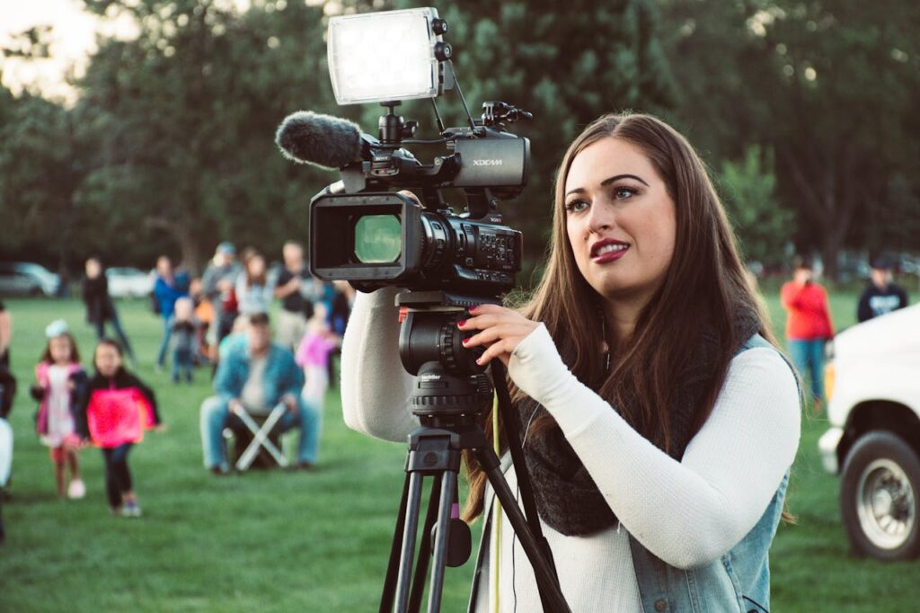 Selective Focus Photo Of A Woman Using Video Camera